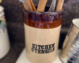 Ceramic utensil crock with wooden kitchen utensils