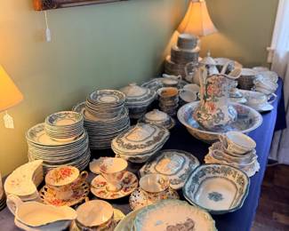 Table of assorted china plates and dinnerware