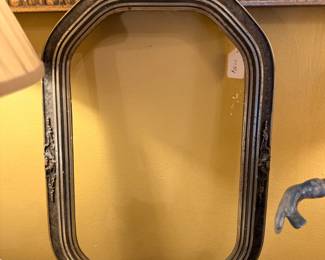 Oval wood-framed wall mirror