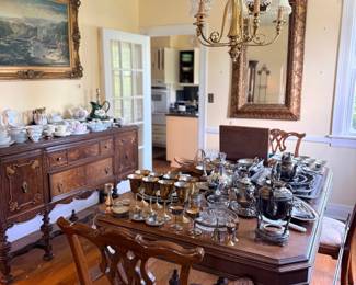Mahogany dining table and antique sideboard with silver and china