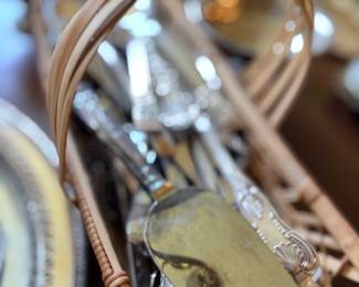 Assorted silver serving utensils and flatware