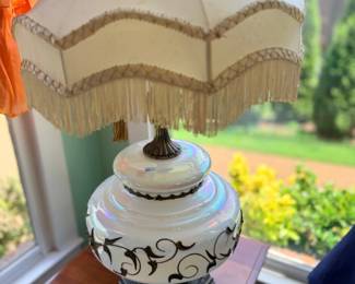Vintage table lamp with fringed shade and scrolled ceramic base