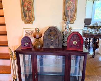 Mahogany glass-door display cabinet with vintage radio collection