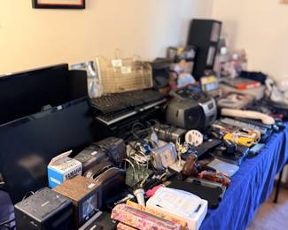 Tables of electronics, tools and miscellaneous items