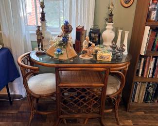 Glass-top rattan dining table with cane chairs