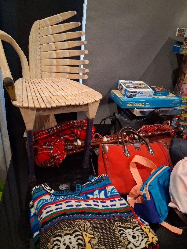 Vintage Coogi Koala knit sweater from Australia; Gerard Rigot hand-painted Swan Chair; Vintage Coach purse; Bagpipes