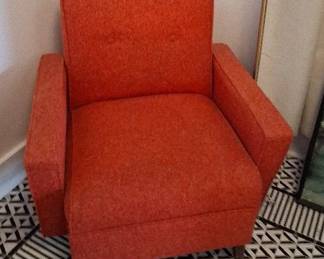 mid-century modern chair featuring muted orange tufted fabric and tapered wooden legs