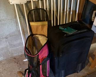 Black Rolling Suitcase and Pink Pet Carrier Backpack