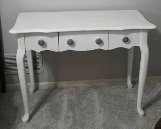White console table with decorative blue knobs