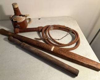 Billy clubs, leather whip, vinyl-covered tequila bottle