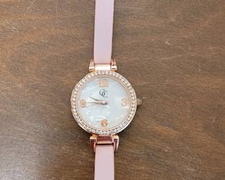 Gold Coast women's analog watch features a rose gold-toned case surrounded by pavé set crystals and a matching pink leather band.