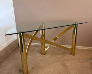 modern gold and glass console table with a geometric Xshaped base