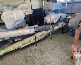 This is us opening the 40+ rugs for photos, measurements, and to check condition.