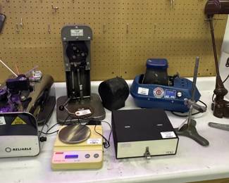 Jeweler tools including scale, inside ring engraver, diamond display, and a Mini-Sonic MT-4SV Compact Electronic Tumbler