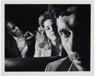 113 Ryan Weideman (b. 1941) "Self Portrait with Black and White Couple," from "In My Taxi: New York After Hours" series, 1988 Gelatin silver print on paper Edition: 6/12 Signed, titled, dated, and inscribed with various numeric notations in pencil, partially indistinct, all verso: Ryan Weideman 1988 / V 3 1/3 / 5.6 / 50 P*** / D-34 / B56291.1A Image: 14" H x 18.375" W; Sheet: 16" H x 20" W Estimate: $1,000 - $1,500