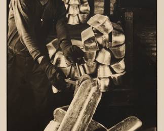 93 Margaret Bourke-White (1904-1971) "Al. Co.," (Factory Worker, Aluminum Company of America), circa 1935 Silver gelatin print on thick paper mounted to paperboard From an edition of unknown size Signed in pencil on the paperboard mount lower right: Bourke / White; with the artist's black ink stamp, " A / Margaret Bourke-White / Photograph," verso; inscribed in black ink, "# 1 / Parklawn," pencil notations "M 2" and "5747," and what appears to be possible remnants of a signature in blue ink (now mostly gone due to removal of old tape), all verso; titled by repute Image/Sheet: 13.5" H x 9.5" W; Mount: 21" H x 14" W Estimate: $6,000 - $8,000