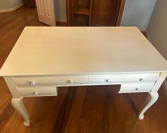 Charming wooden vintage desk with a white painted finish, curved legs, and eight drawers for storage (4 drawers on both sides). Perfect for a home office workspace.