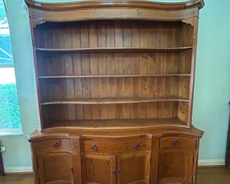 Elegant solid wood hutch with open shelving, cabinet storage, and curved detailing. Perfect for displaying dishes, collectibles, or décor while providing ample concealed storage below.