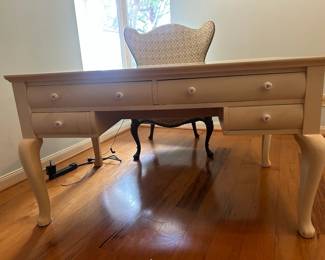 Charming wooden vintage desk with a white painted finish, curved legs, and eight drawers for storage (4 drawers on both sides). Perfect for a home office workspace.