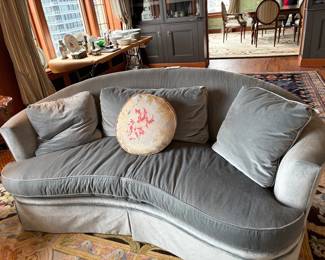 $5200. Pair of velvet upholstered curved back sofas in a beautiful icy slate blue. Sheen on fabric is due to lighting not wear.  75 inches wide 36 inches deep by 32 inches high down and down wrapped cushions.