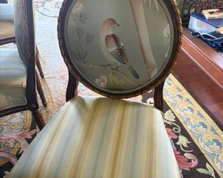 Close-up of one of the side chairs. Each measures 24 inches wide by 19 1/2 inches deep by 40 1/2 inches high. Each back panel features a different bird.