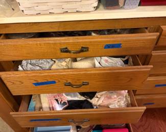 Drawers packed with socks, bras, panties, scarves, wigs and toiletries 