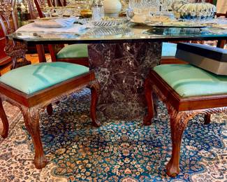 Lovely glass top marble based dining table with 8 green dining chairs.