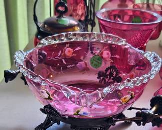 Victorian-style bride's basket features a pink, footed cranberry glass bowl decorated with hand-painted flowers