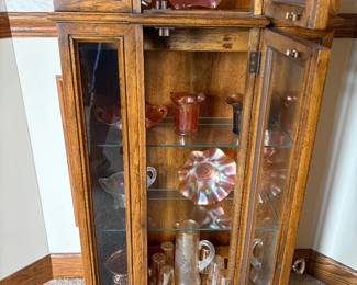 Curio cabinet full of Carnival Glass