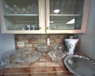 Three cake display stands, pewter serving tray, crystal bowls, Oscar de la Renta crystal wine goblets (21), no name crystal wine goblets, other miscellaneous glassware.