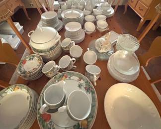 Table of several sets of dinnerware from Wedgewood Home, Baum Bros. Porcelain.