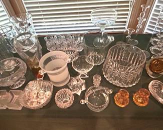 Table of miscellaneous crystal and handblown glass collectibles, candlestick holders, vases, dishes.