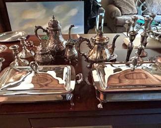 Table of silverplated and sterling silver pieces.