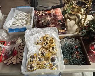 Table with all kinds of Christmas ornaments, holiday decor