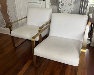 Pair of cream linen chairs with brass frame. 28”w x 36”d x 30”h.