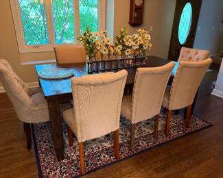 Farmhouse style dining table, upholstered chairs, area rug