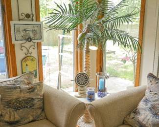 Coastal Palm Tree Floor Lamp Lighted Tropical Palm Tree Floor Lamp Unique tropical palm tree floor lamp featuring a realistic palm trunk, detailed fronds, and integrated accent lighting. A standout decorative piece that brings a relaxed coastal, Florida, or island-inspired feel to any room.  Perfect for a sunroom, beach house, lake home, tiki bar, Florida room, or tropical-themed living space. Functions as both decorative artwork and accent lighting.  Features:  Realistic palm tree design Integrated accent lighting Detailed palm fronds and textured trunk Freestanding floor lamp Tropical, coastal, and island-inspired décor Creates a warm ambient glow Also available nearby: Lighthouse wall décor Nautical wall art Ship's wheel clock Coastal accent furnishings and decorative accessories