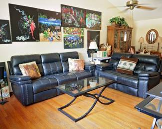 Living Room Collection Beautiful living room furnishings and artwork collection featuring: Black leather power reclining sofa with dual recliners Matching black leather loveseat Contemporary black metal and glass coffee table Matching modern black metal and glass sofa/console tables (set of 3) Large collection of Michael Godard signed lithographs and framed artwork Lighted oak china/display cabinet Decorative mirrors, lamps, baskets, and Florida-inspired décor accents The Michael Godard collection includes multiple large-format canvas lithographs featuring the artist's iconic martini, olive, tropical, automotive, and nightlife themes. Several oversized statement pieces available. Excellent opportunity to furnish an entire room with coordinated contemporary furniture and collectible artwork.