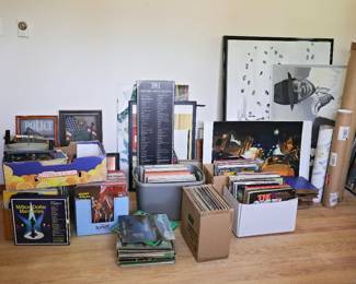 Vinyl Records, Turntable & Classic Entertainment Memorabilia Music lovers and collectors will find plenty to explore in this diverse collection featuring vintage vinyl records, a record player, framed artwork, movie memorabilia, and decorative prints. Browse through boxes of albums spanning multiple genres, from big band and easy listening to classic favorites and nostalgic recordings. Highlights Include: Large assortment of vinyl LP records and albums Vintage record player/turntable Framed Rat Pack artwork featuring classic entertainers "100 Greatest Movie Quotes" collector display Movie and entertainment-themed artwork and prints Framed police and patriotic wall décor Decorative cityscape and fine art prints Assorted framed artwork, posters, and collectible prints Whether you're a vinyl enthusiast, movie buff, decorator, or collector of classic Americana, this area offers a wide variety of unique finds and nostalgic treasures.