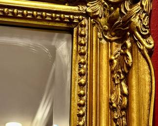 This  vintage gold mirror features an ornate baroque-style frame suitable for decorating a living room or entryway. Measures 60" W x 36" H 