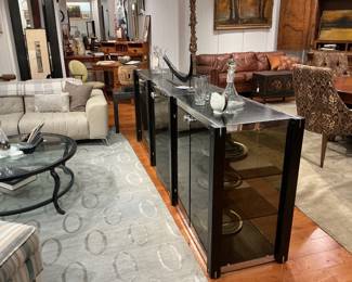 Contemporary Black Lacquered Credenza / Sideboard Description: A sleek, modern four-door buffet featuring a satin black lacquered finish, oversized industrial-style cylindrical door handles, and clean plinth base styling. Estimated Dimensions: Width: 72" Depth: 18" Height: 34"