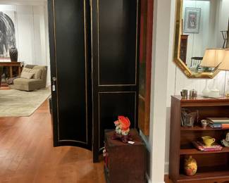 Neoclassical Style Black Lacquered Armoire / Wardrobe Description: A dramatic, tall two-door armoire featuring a striking satin black lacquered finish accented with elegant gold gilt pinstripe detailing. Built with an architectural presence, it showcases a bold crown molding top and a distinctive arched, concave apron base. The two large cabinet doors swing wide to reveal a spacious, deep-set matte black interior equipped with an upper hanging rod—making it highly versatile for use as a traditional wardrobe, garment storage, or a statement entryway coat closet. Estimated Dimensions: Width: 48" Depth: 24" Height: 82"