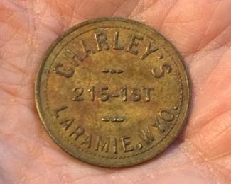 1890s Trade Token Charleys 215-1st St Laramie Wyoming. Charley's was a bar on 1st Street in Laramie, Wyoming in the 1890s. This 1 1/8" token was for 25 cents in trade, which would buy a cowboy two drinks at the going rates of 12.5 cents per drink. At that time, 1st Street was the commercial district near the railroad depot and a hub for saloons and cigar stores.