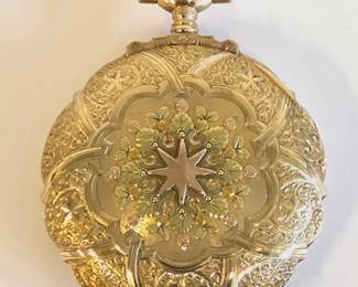 Antique 17 jewel, 16 size stem set Hamilton pocket watch in an extraordinary and ornate 14 karat tricolor gold box hinged hunter case. The intricate gold designs are different on each side. The watch has an unblemished Montgomery Dial and the works are adjusted to 3 positions. The serial number is 1,241,470, dating it to 1915. It is running and keeping good time.