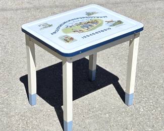 Childs enamel top table with lithographed nursery rhymes and alphabet.