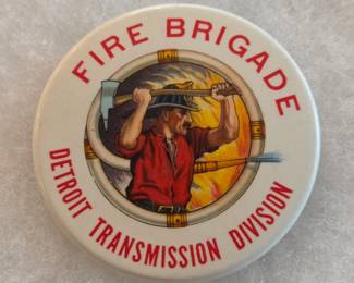This rare 2" diameter celluloid pin back button was a badge worn by a member of the Fire Brigade of the Detroit Transmission Division, a branch of General Motors formed in 1939 to manufacture the famous Hydra-Matic transmission. General Motors plants had fire brigades made up of regular workers who were trained to serve as first responders for fires and industrial accidents. On August 12, 1953, this plant had a catastrophic fire and many members of the Fire Brigade died.  The button was made by Whitehead & Hoag. It is in excellent condition as it was carefully stored out of the light for several decades. Many other pin back buttons from this collection, most in excellent condition and many from the 1890s, are also offered in this auction. 