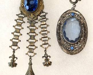 CORO Victorian Revival 4 1/4" Dress Clip & Pendant. Includes: 1) CORO Victorian Revival costume jewelry dress clip from the 1930/1940s.. The design reflects the chatelaine aesthetic with fleur-de-lis and a glass imitation sapphire. 2) 2" long Victorian revival style pendant
