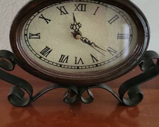 Black Ornate Oval Metal Clock with Scroll Stand