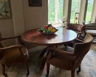 Round Copper-Topped Dining Table with three Upholstered Chairs