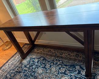 Beautiful solid wood table with fold out sides and top to make larger 